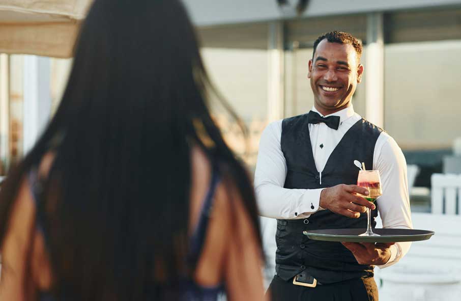Serving Drinks to Guests Aboard a Yacht
